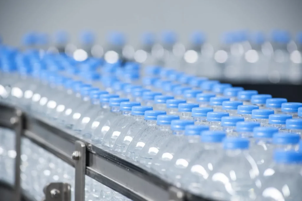 The Hidden Benefits of Drinking More Water 5 water bottles on assembly line