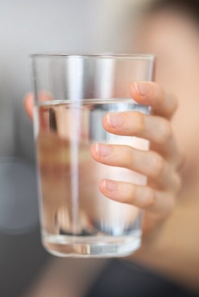 Full water glass being held